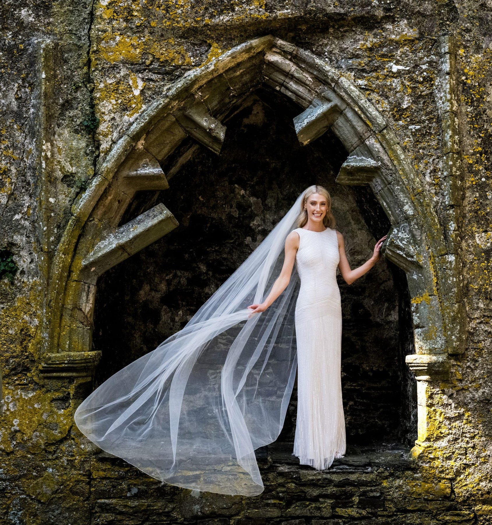 Bride in a stone archway wearing a veil